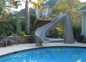 Pool with a slide going into the water.